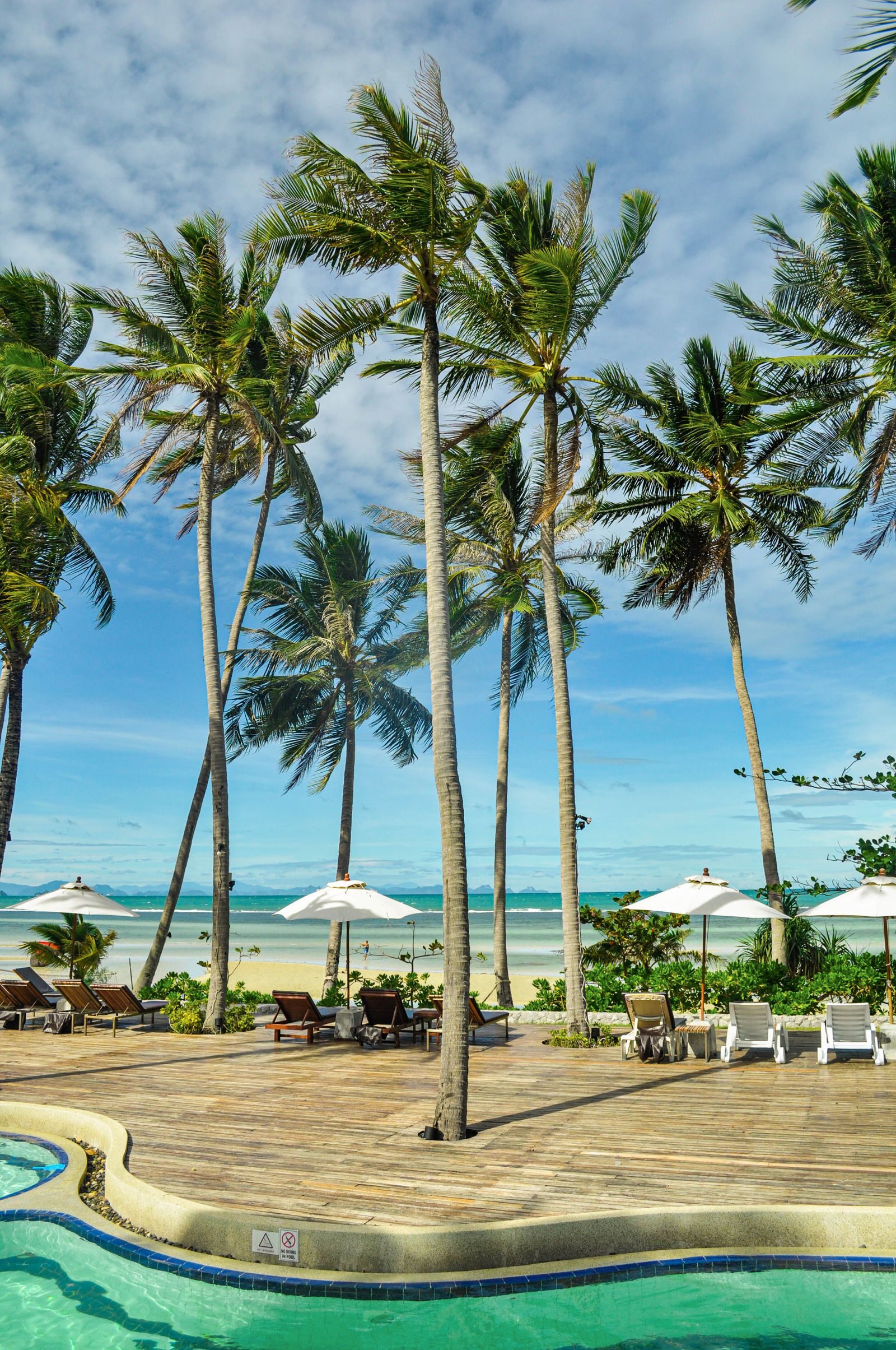 Kesari's beachfront — swaying palms, sun loungers and a pool set back from the sand on Haad Yao